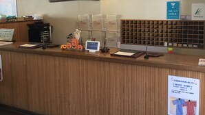 A reception desk with a wooden finish, a computer monitor, a sign indicating free Wi-Fi, and a display of shoes. - Karuizawa Hotel PAIPU NO KEMURI (Karuizawa)