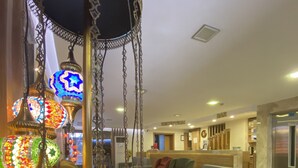 A modern living room with a reception area, sofas, and a coffee table. - Polanin Hotel (Istanbul)