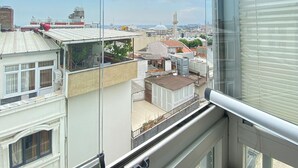 A high-rise building with a view of the cityscape, including a prominent tower and various buildings. - Polanin Hotel (Istanbul)