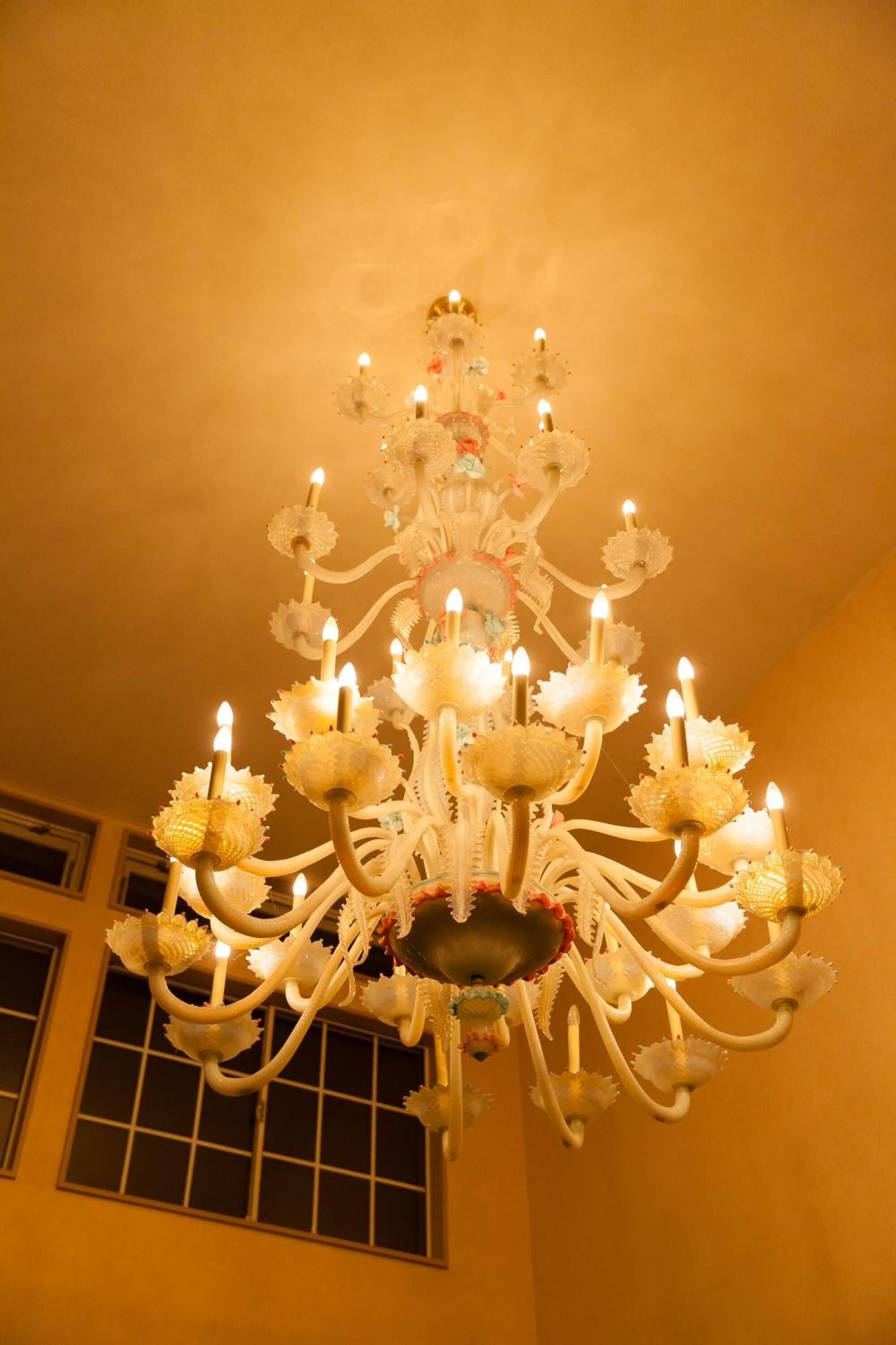 A chandelier with multiple arms and candle-like lights.