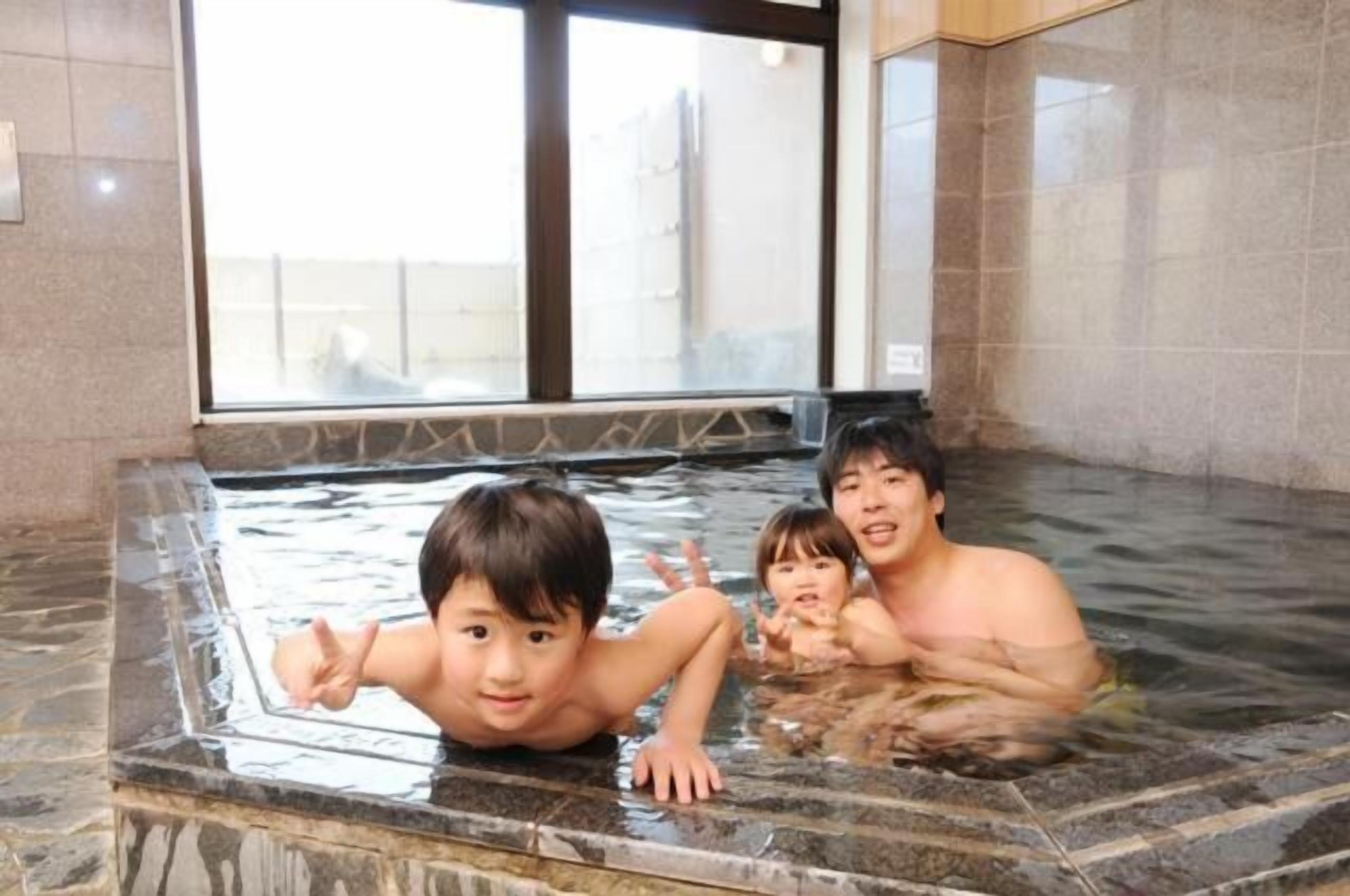 A hot spring area with tiled walls and a window in the background.
