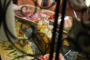 A breakfast buffet with various food items and beverages.