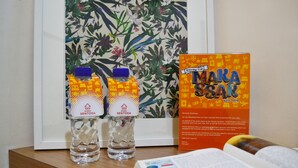 Two water bottles labeled 'WISMA SENTOSA' and a framed welcome sign for 'WIMA SENTOSA'. - Wisma Sentosa (Makassar)