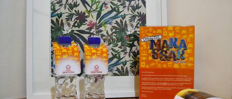 Two water bottles labeled 'WISMA SENTOSA' and a framed welcome sign for 'WIMA SENTOSA'.