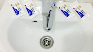 A white sink with a chrome faucet and a drain. - Ikaros Hotel (Piraeus)