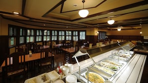 A buffet area with multiple food stations and a seating area with tables and chairs. - Hakuba PAIPU NO KEMURI (Hakuba)