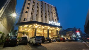 A hotel with a modern facade, multiple floors, and a prominent sign indicating it is Hotel 88. - Hotel 88 Fatmawati Jakarta by WH (Jakarta)