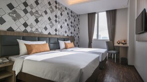 A hotel room with a large bed, a desk, and a TV. - Hotel 88 Fatmawati Jakarta by WH (Jakarta)