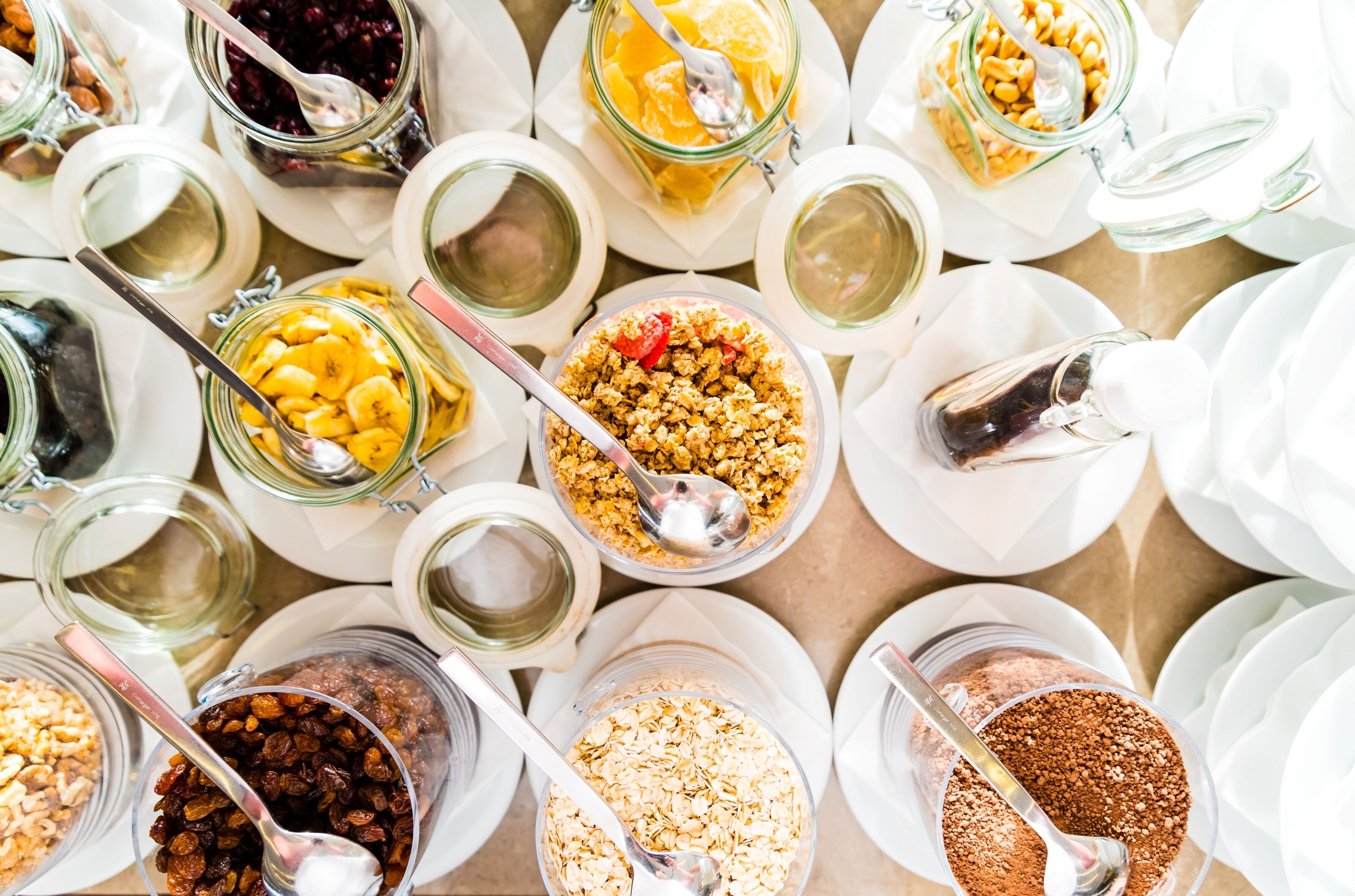 A variety of food items and utensils arranged on a table.