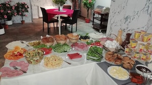 A buffet table with various food items and a grill station. - London Palace (Tbilisi)