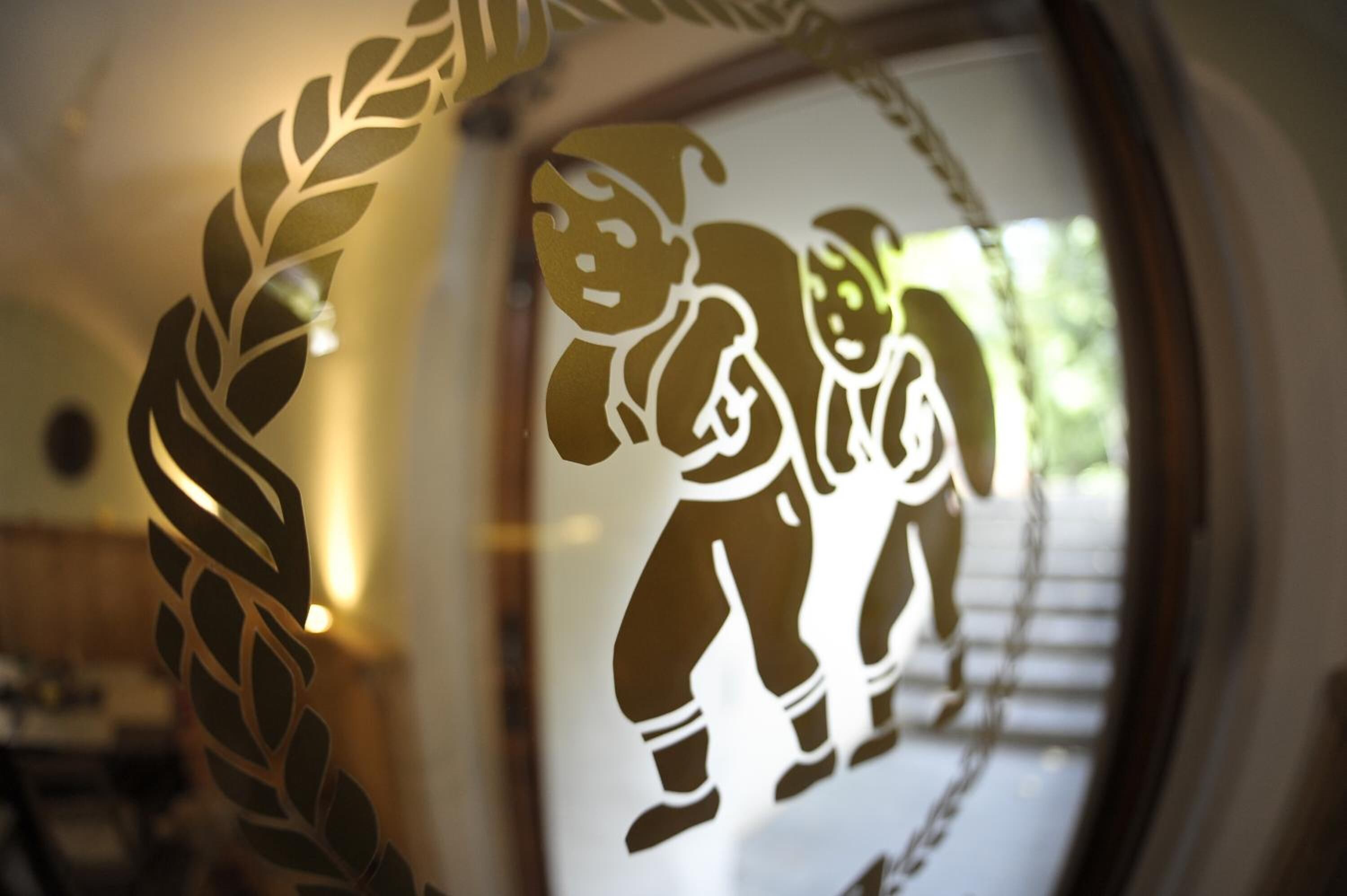 A window with a decorative cut-out featuring two figures.