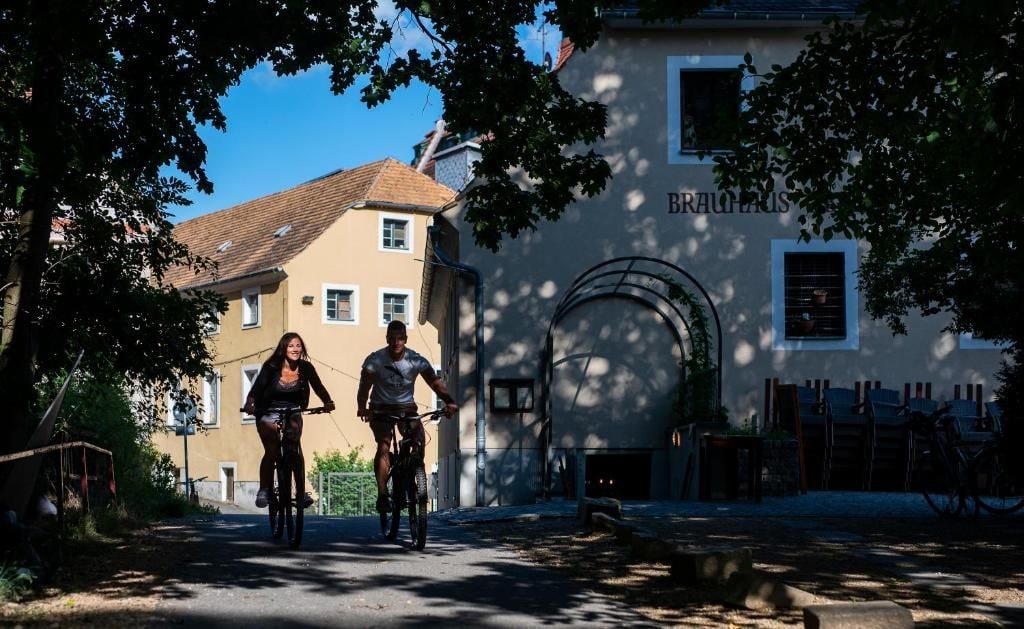 A building with a sign 'BRAUHAUS' and a bicycle parked in front.