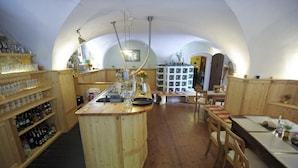 A rustic kitchen with wooden cabinets, a central island, and a variety of kitchenware. - Obermühle Görlitz (Görlitz)