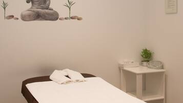 Relax in a peaceful space with a meditation area, featuring a serene statue, a plant, and a clock.