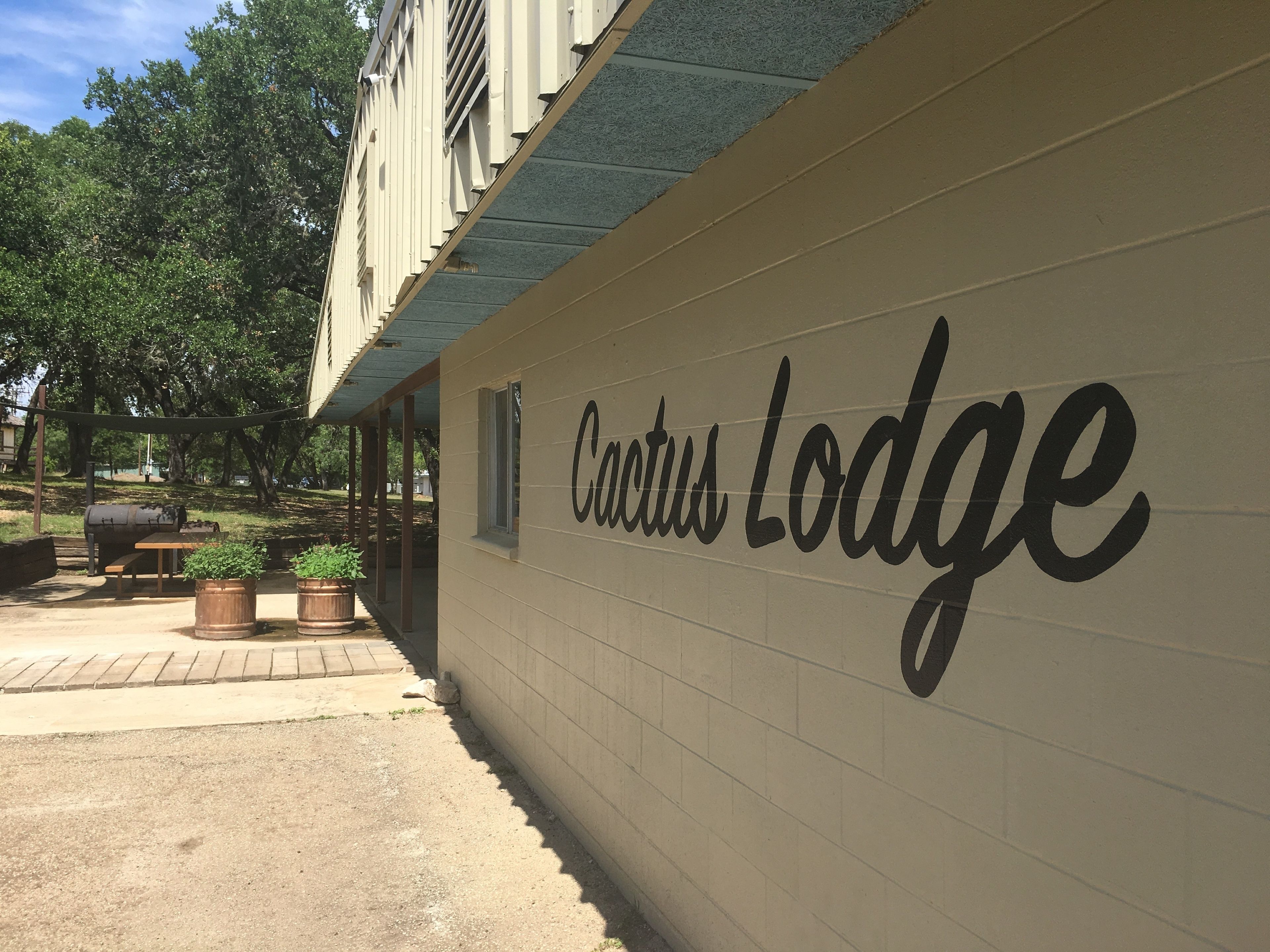 A wall with the text "Cactus Lodge" indicating the name of the establishment.