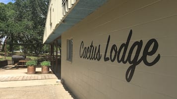 A wall with the text "Cactus Lodge" indicating the name of the establishment.
