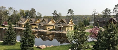 A row of modern houses with a lake in the background.
