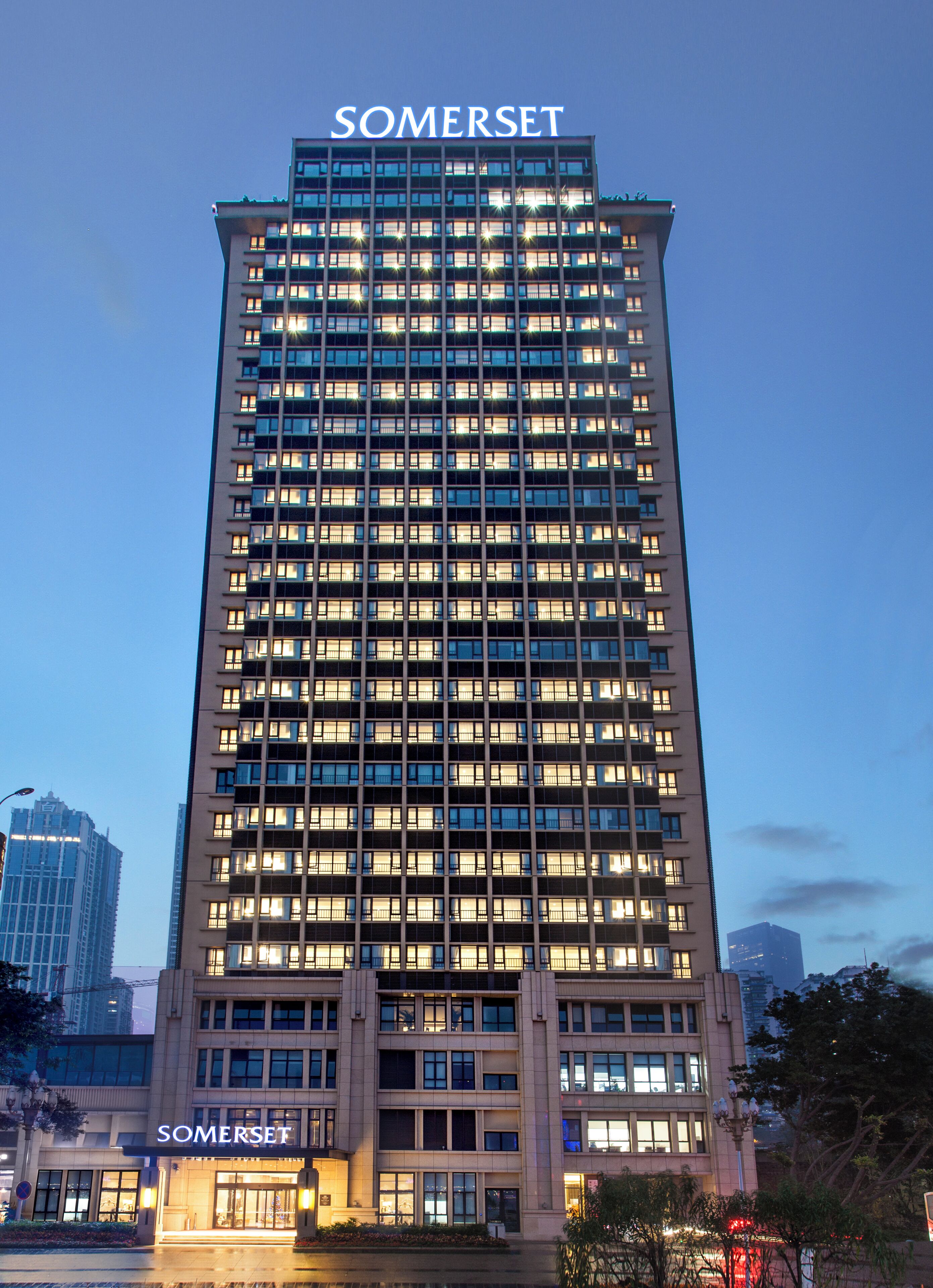 A tall, modern hotel with a prominent 'SOMERSET' sign at the top.