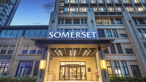 A modern building with a prominent entrance and the name "SOMERSET" displayed above.