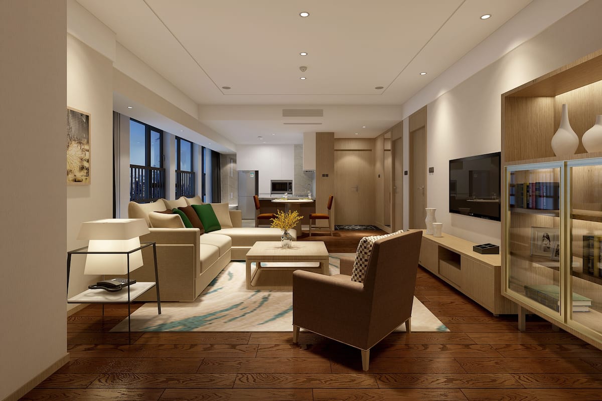 A modern living room with a sofa, armchairs, a coffee table, and a TV.