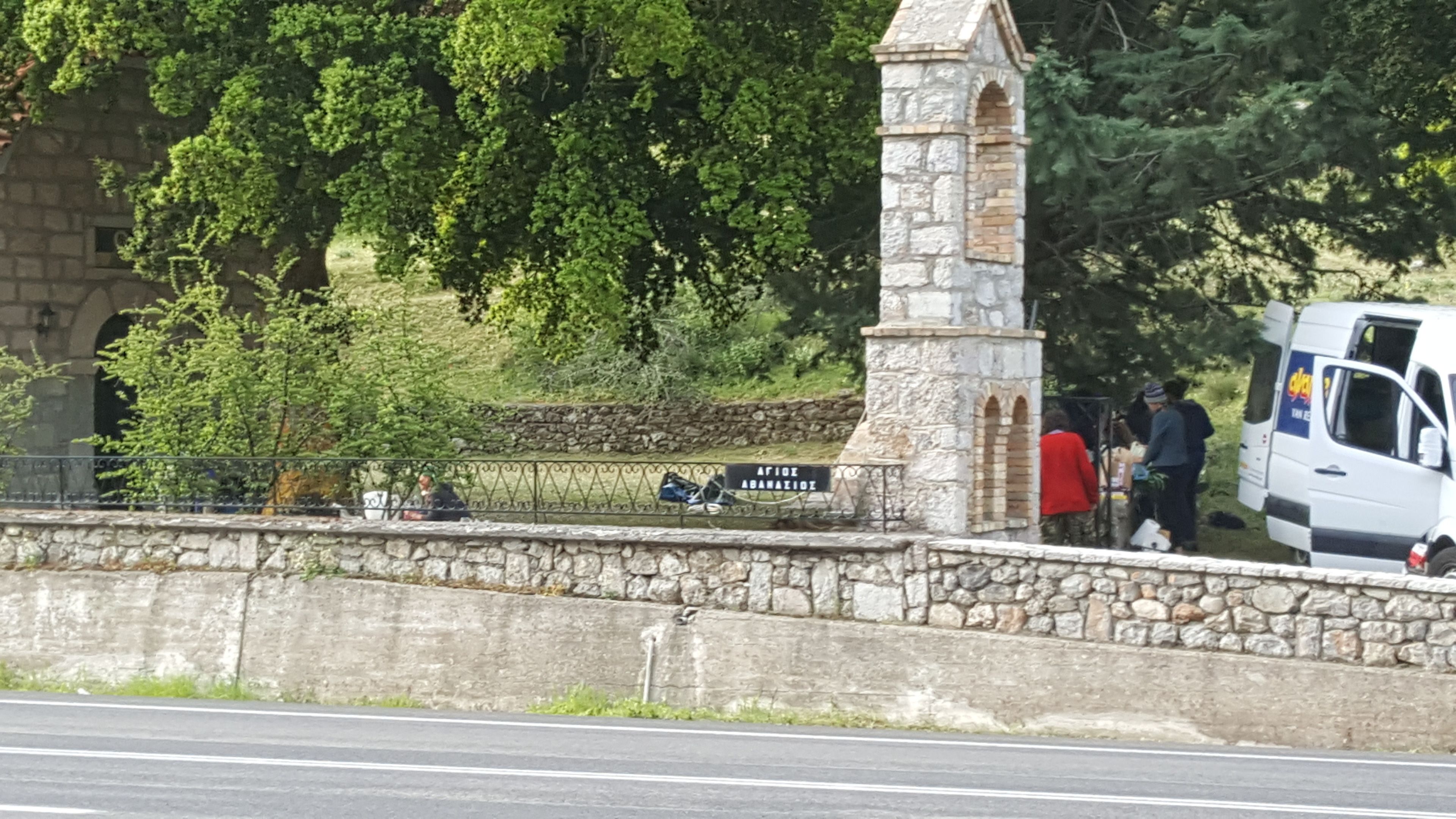 A stone structure with a sign reading "AFIOE ABANAZIDE" near a road.
