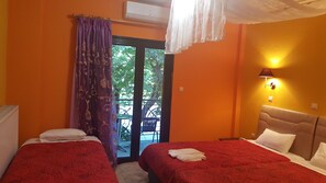 A hotel room with two beds, a balcony, an air conditioning unit, and a wall-mounted lamp. - Hani Zemenou (Distomo-Arachova-Antikyra)
