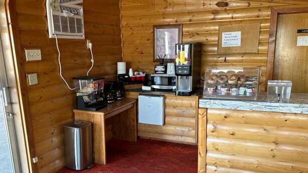 A compact kitchen with a microwave, coffee maker, and a small refrigerator. - Love Hotels Western Holiday by OYO at Harlan Lake NE (Alma)