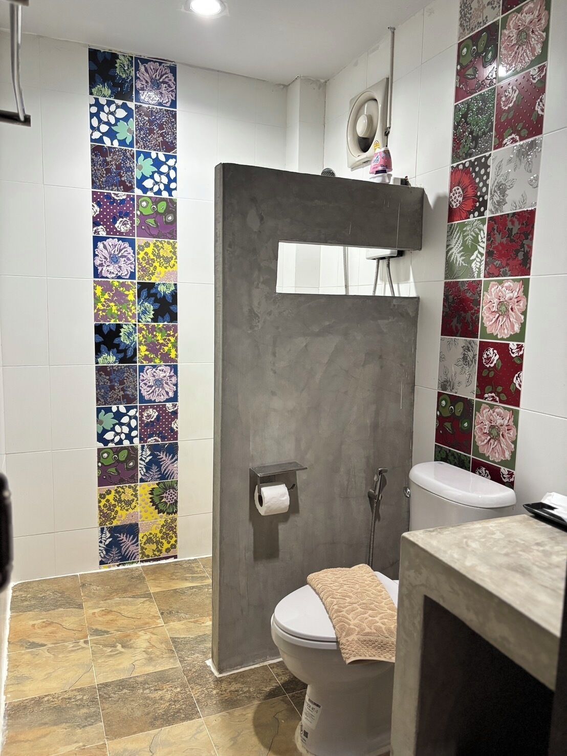 A bathroom with a shower, toilet, and sink.