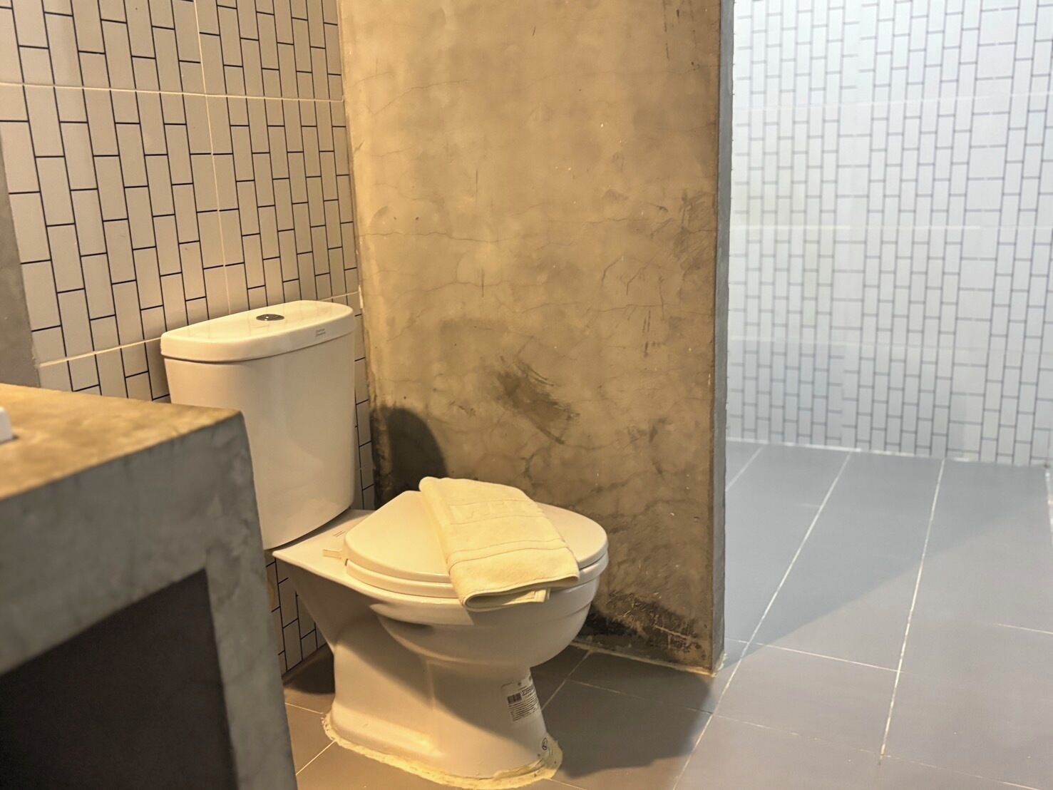 A bathroom with a toilet, a sink, and tiled walls.