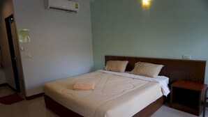 Quarto de hotel com cama, mesa de cabeceira e ar condicionado.
