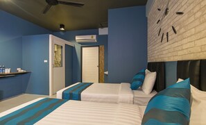 A hotel room with two beds, a bathroom, and a small sitting area. - Amity Poshtel - Hostel (Krabi)
