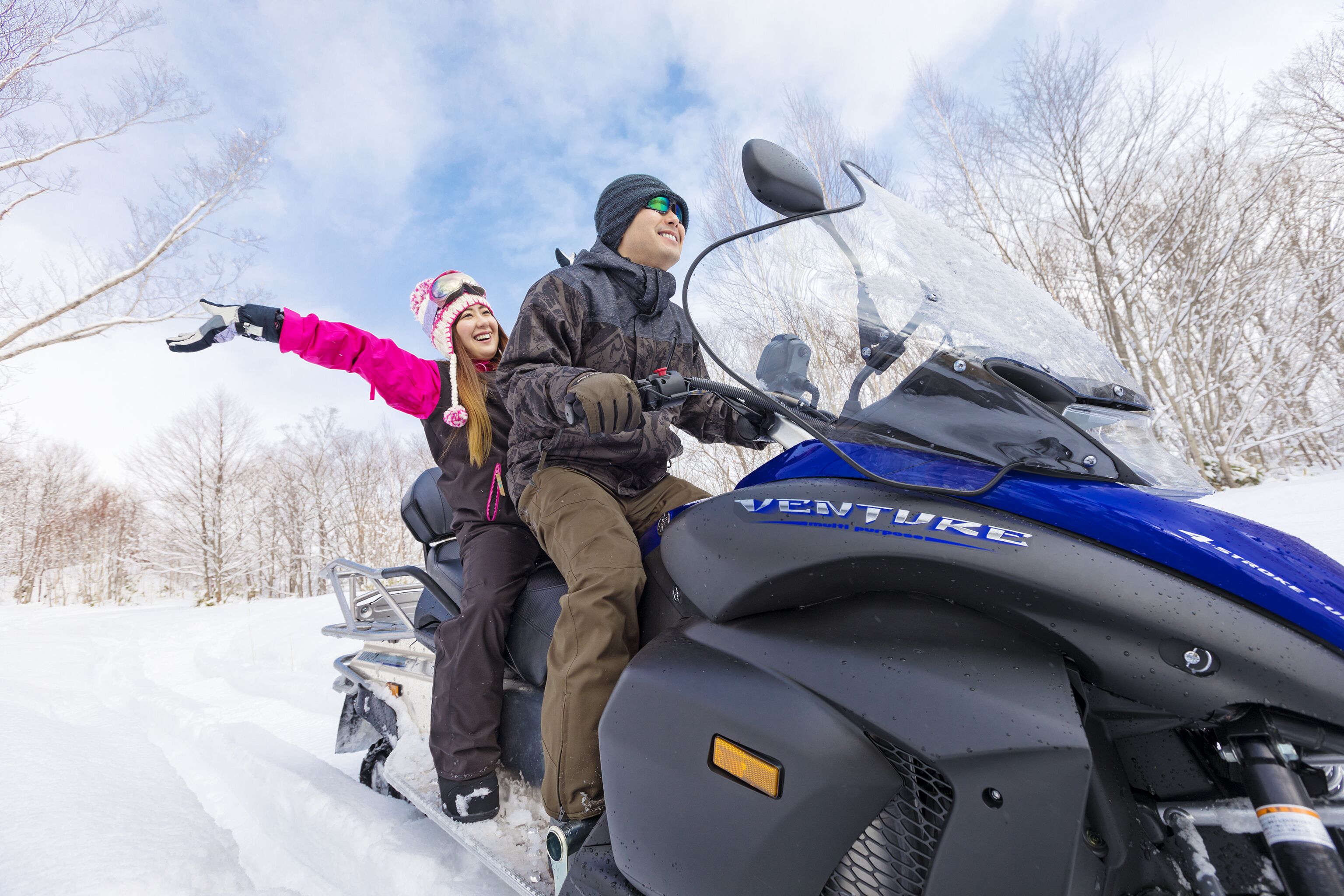 A snowmobile with the brand name "VENTURE" on the front.