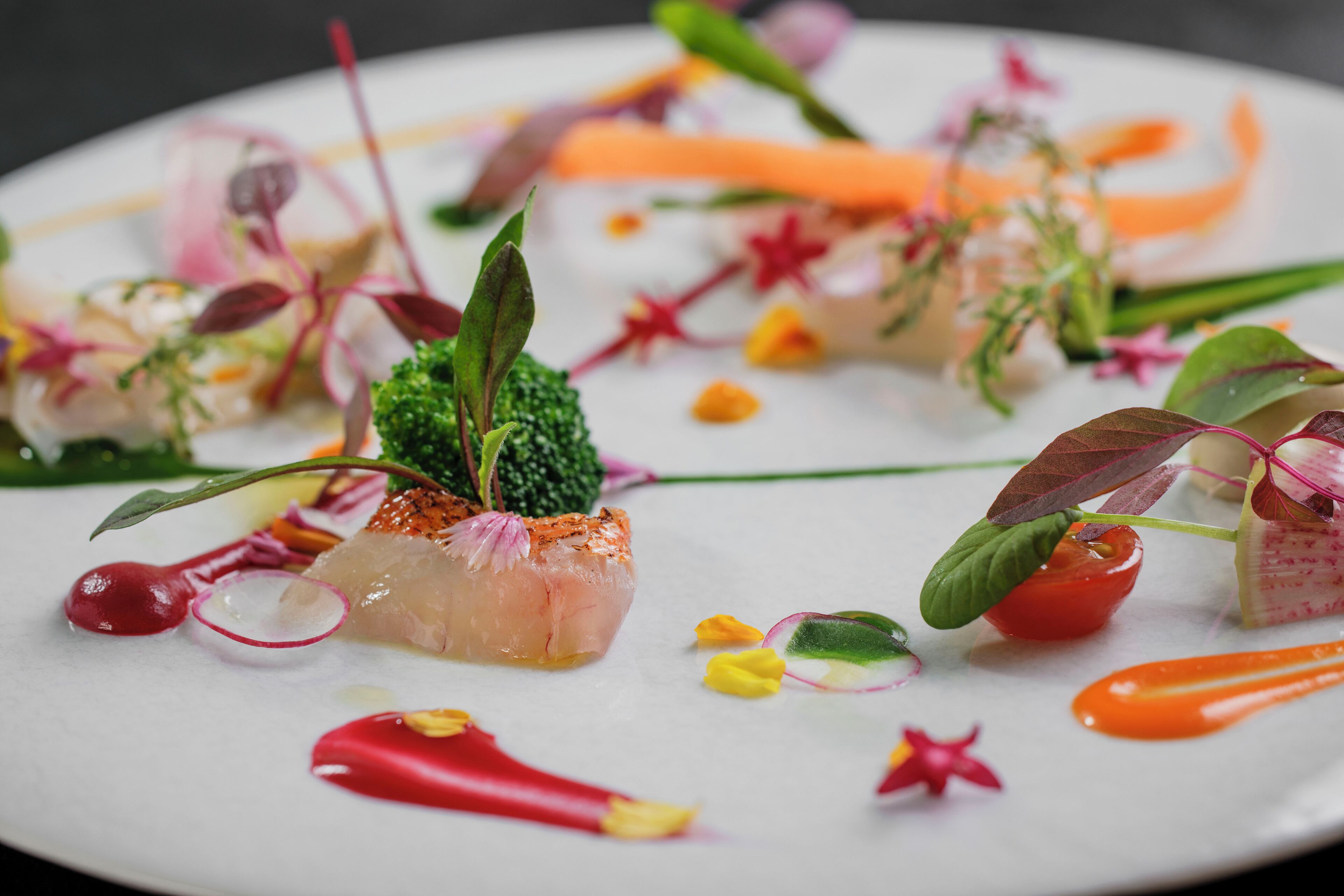 A plate of food with various garnishes and sauces.