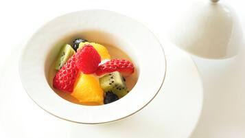 A bowl of fruit dessert on a white table.
