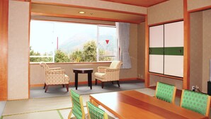 A traditional Japanese-style room with tatami flooring, a low wooden table, and two tatami mats with cushions. - Awanosho (Miyoshi)