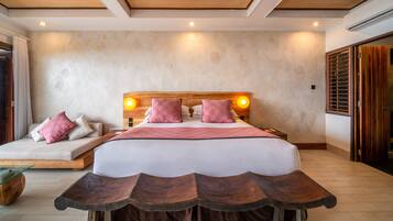 A bedroom with a large bed, wooden headboard, and bedside lamps.