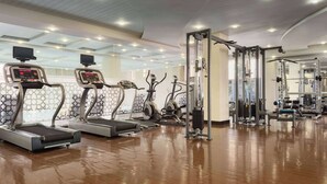 A gym with treadmills, elliptical machines, and weightlifting equipment. - Ramada by Wyndham Islamabad (Islamabad)
