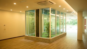 A modern interior with a glass enclosure containing a small indoor garden.
