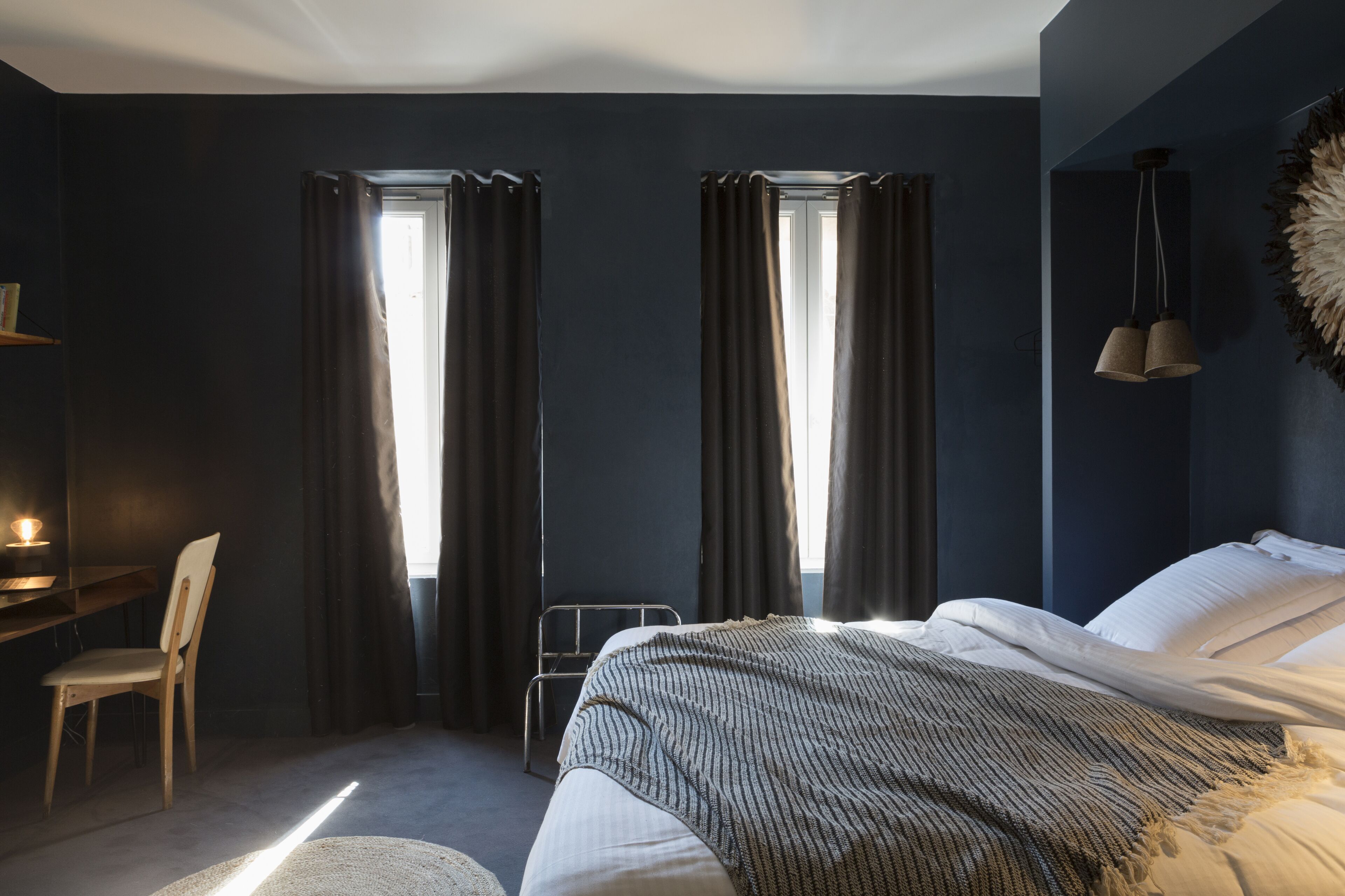 Un dormitorio moderno con cama, escritorio y silla.