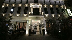 A historic building with a grand entrance, multiple windows, and a well-lit facade. - The Mansion Boutique Hotel (Bucharest)
