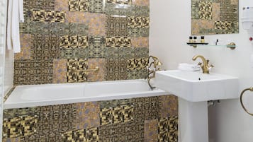 A bathroom with a bathtub, a white sink, and a mirror. The walls are decorated with a circuit board pattern.