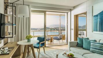 A modern living room with a balcony, a dining area, and a sofa.