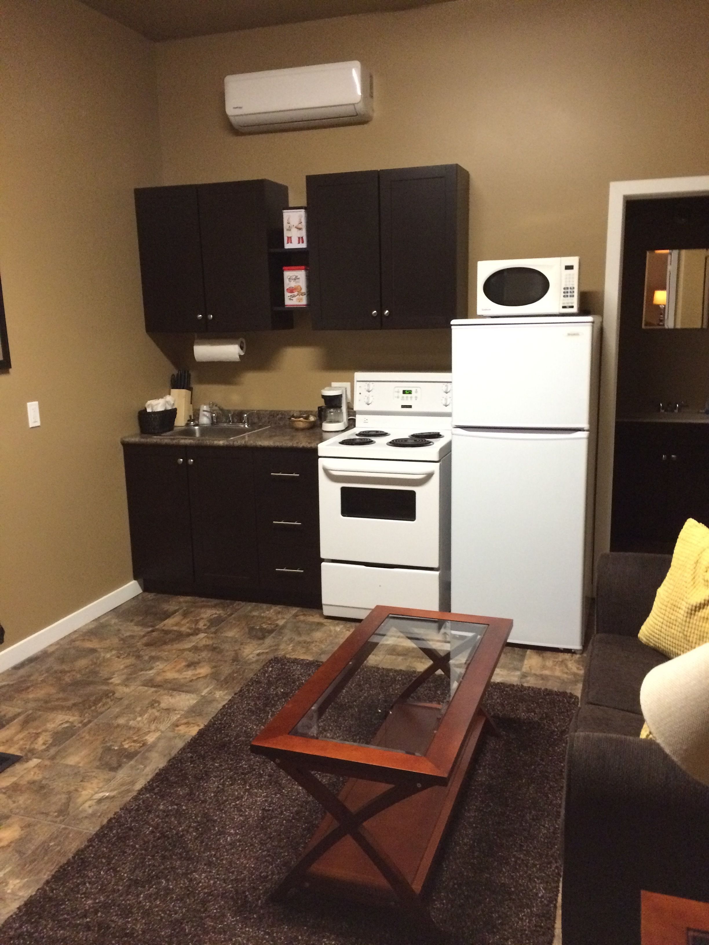 premium suite, 1 king bed, kitchenette | private kitchenette | fridge, microwave, coffee/tea maker