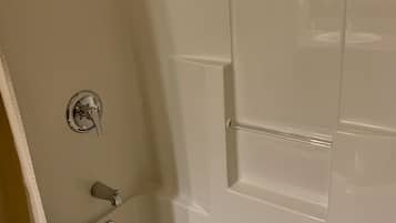 A bathroom with a bathtub, a shower, and a toilet.