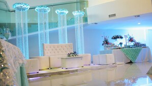 A modern hotel lobby with a seating area, a reception desk, and decorative crystal chandeliers. - Hotel El Camino Inn & Suites (Reynosa)