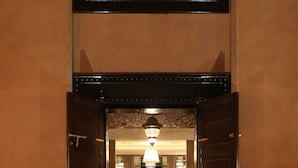 A hotel lobby with a red carpet leading to a seating area and a bed. - Dar Sofil - Adults Only (Marrakech)
