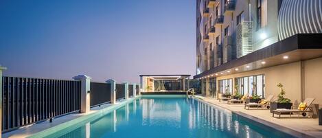 Seasonal outdoor pool, open 9:00 AM to 9:00 PM, pool umbrellas