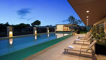 Seasonal outdoor pool, open 9:00 AM to 9:00 PM, pool umbrellas