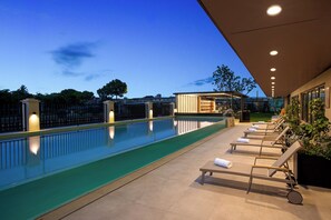 Seasonal outdoor pool, open 9:00 AM to 9:00 PM, pool umbrellas