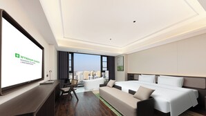 A modern hotel room with a large bed, a sofa, a desk, and a large window offering a city view. - Wyndham Garden Shanghai Pudong (Shanghai)